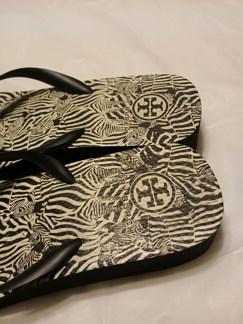 Tory Burch Ladies Black Zebra Flip Flops with Gold Logo